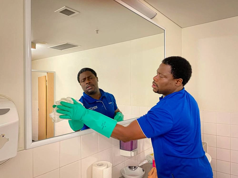 man cleaning the mirror