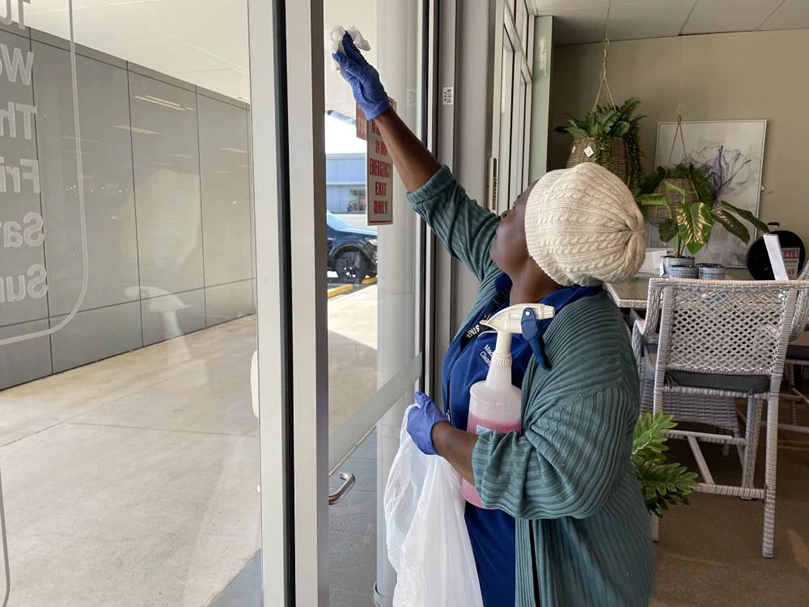 team member window cleaning